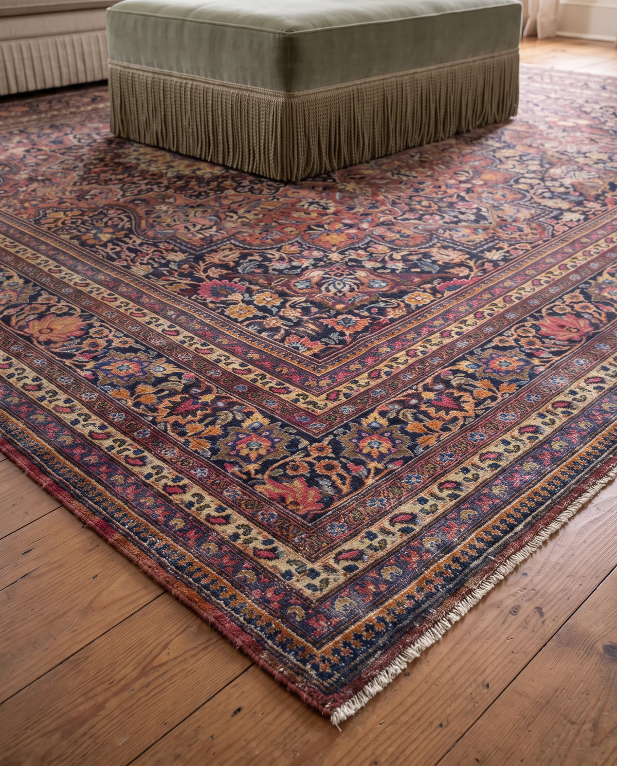 Vintage Persian Moud rug with a dark floral Herati pattern, lustrous wool pile, and fringed edges on a timber floor.