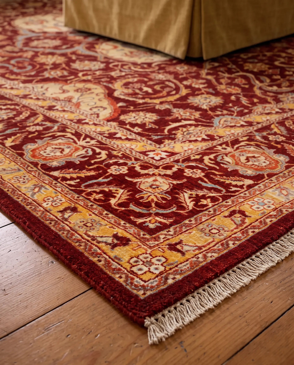 Hand-knotted Afghan Balkh rug in deep red with intricate floral patterns, gold borders, and a fine wool fringe.