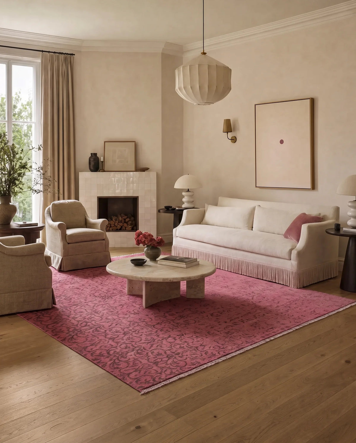 Hand-knotted Afghan Chobi rug in a saturated pink tone with a subtle tribal pattern, styled in a contemporary living room.