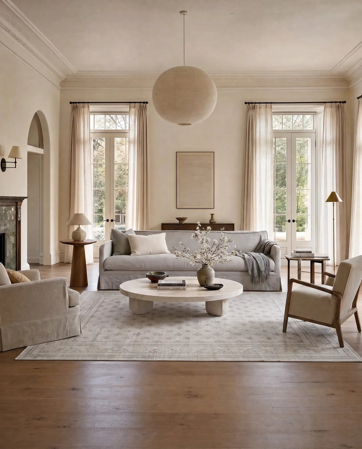 Hand-knotted Afghan Chobi rug with a subtle grey and cream geometric pattern in a light-filled living room.