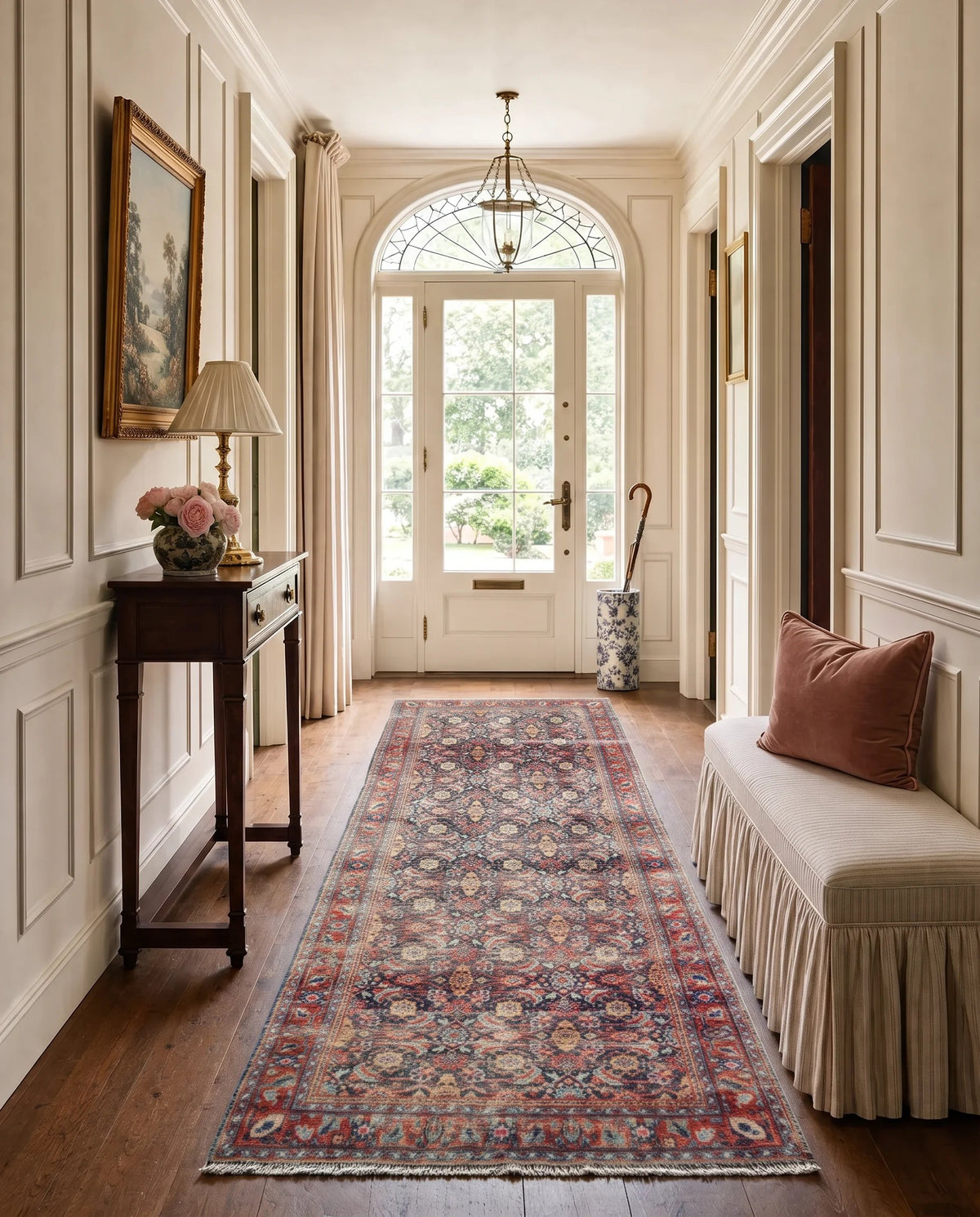 Vintage Persian Malayer runner with intricate floral patterns in deep indigo and rust red laid in a bright hallway.