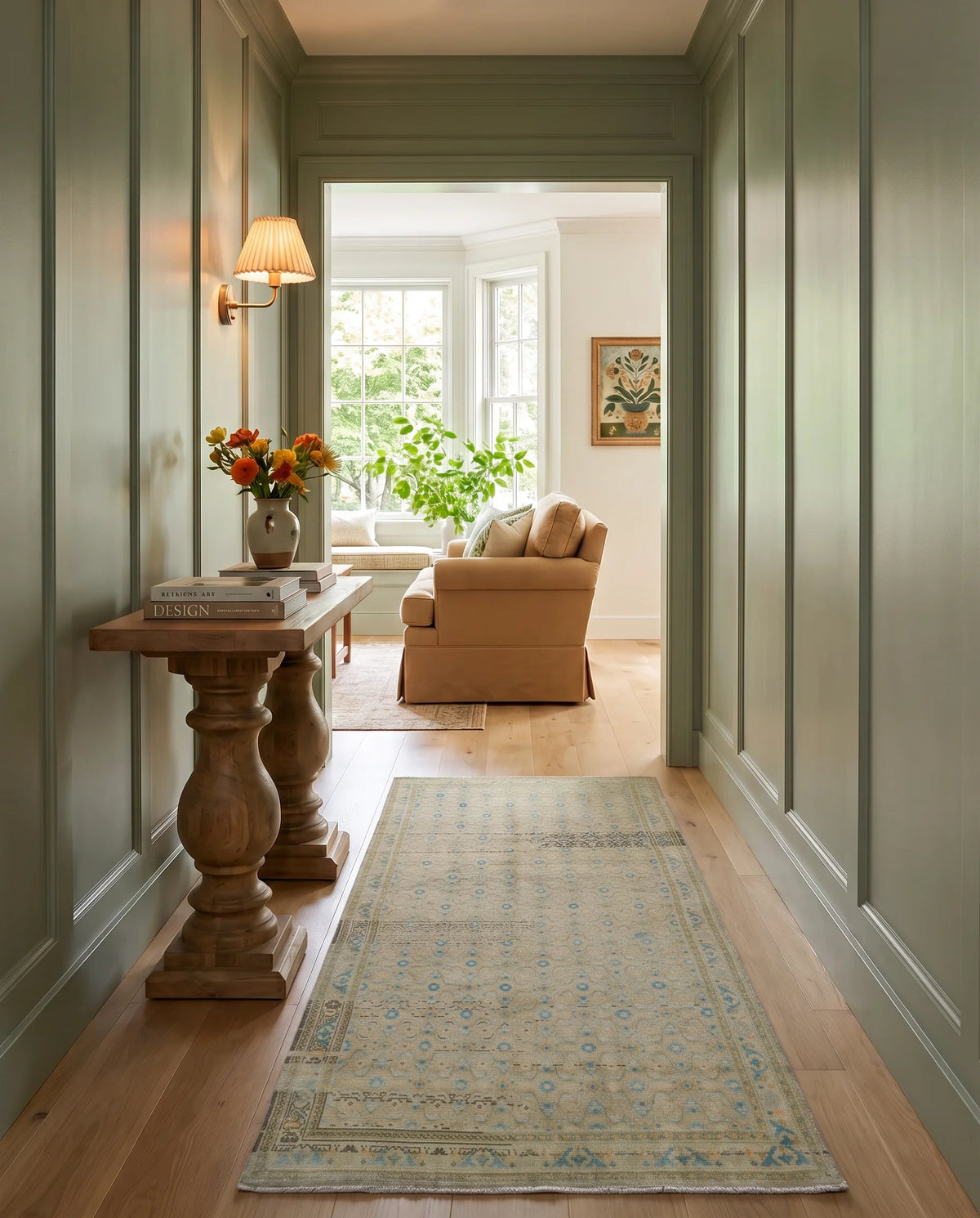 Vintage Malayer runner with intricate blue and ivory floral patterns on a timber floor in a sage green hallway.