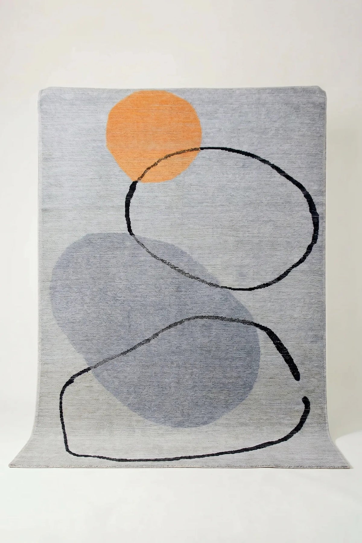 Hand-knotted Afghan wool rug featuring abstract grey shapes, a vibrant orange circle, and black line art.