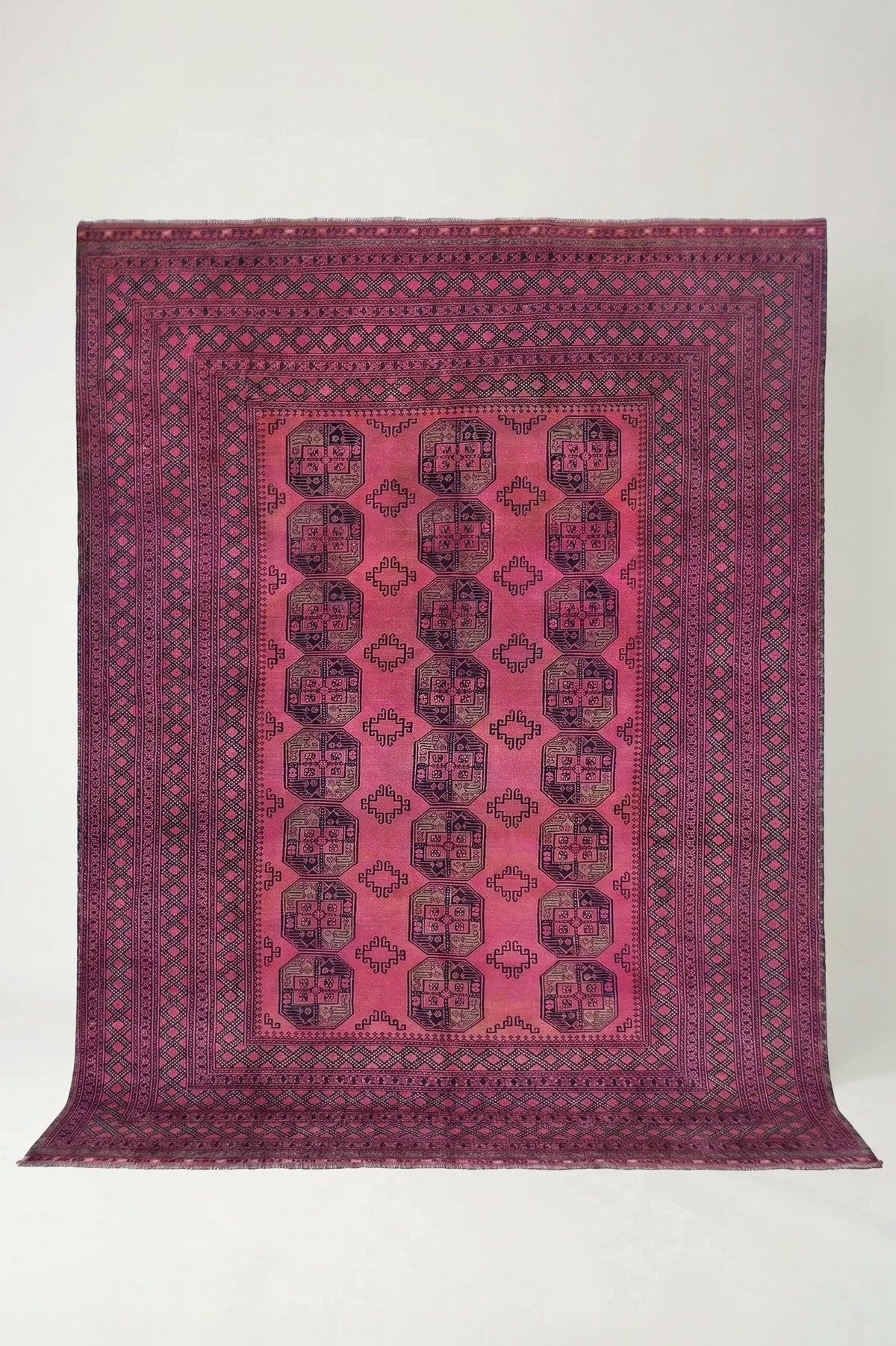 Hand-knotted vintage Turkmen Ersari rug featuring deep red tones and repeating elephant's foot guls on wool.