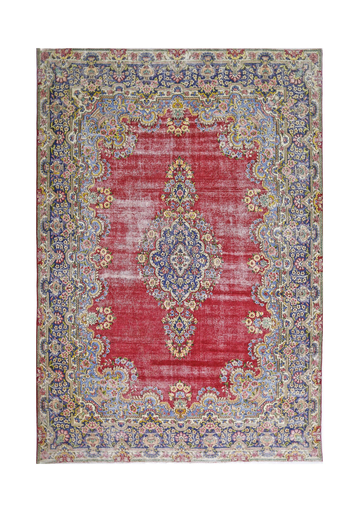 Vintage hand-knotted Persian Kerman rug featuring a central floral medallion on a red field with blue ornate borders.