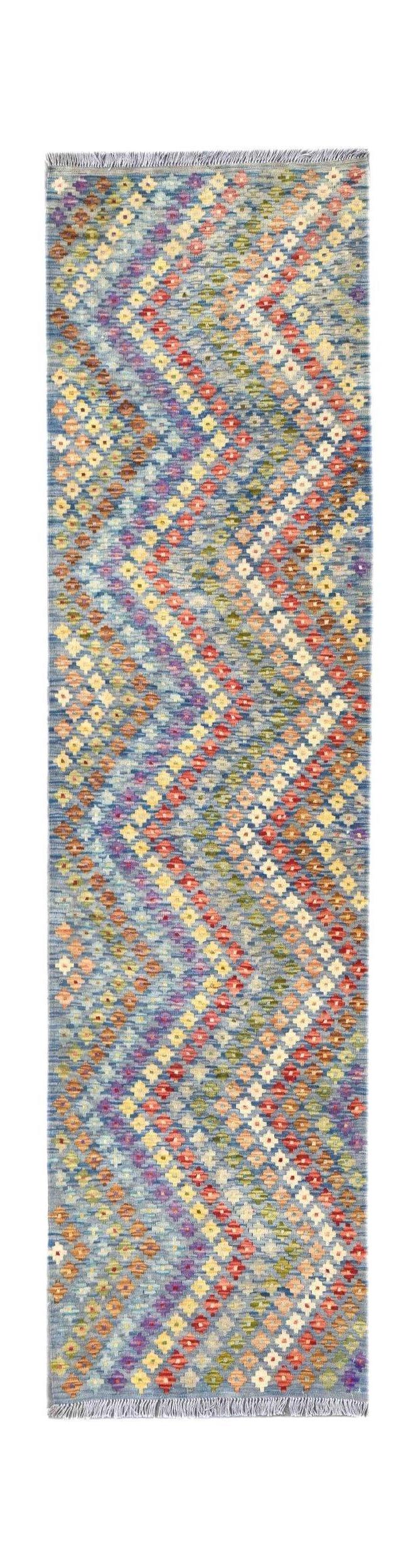 Handmade Afghan Maimana wool runner rug featuring a colorful geometric chevron pattern.