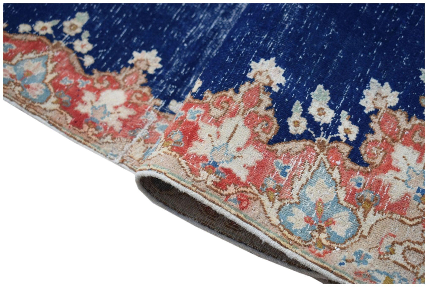 A vintage Persian Kerman runner featuring a deep blue field with intricate floral border patterns.