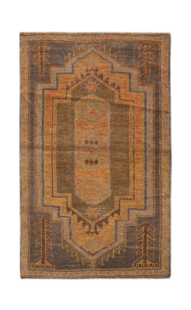 Handmade Afghan Baluch rug featuring a geometric medallion pattern in shades of brown and orange.