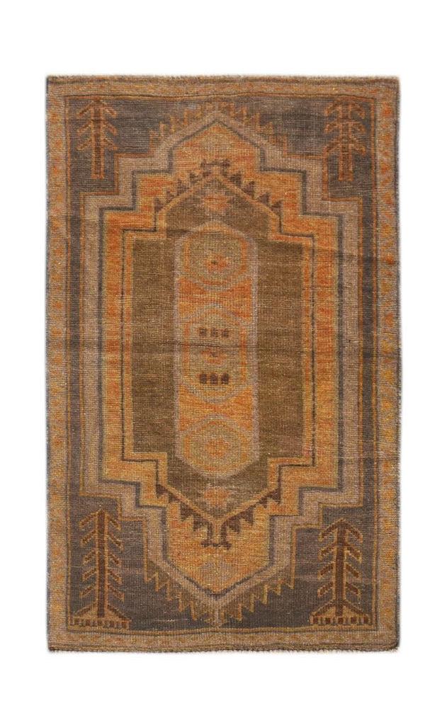 Handmade Afghan Baluch rug featuring a geometric medallion in shades of brown and orange.