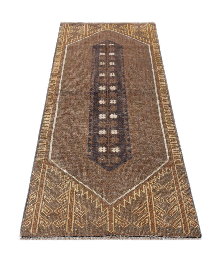 A handmade Afghan Baluch rug featuring a brown field with a central geometric medallion.