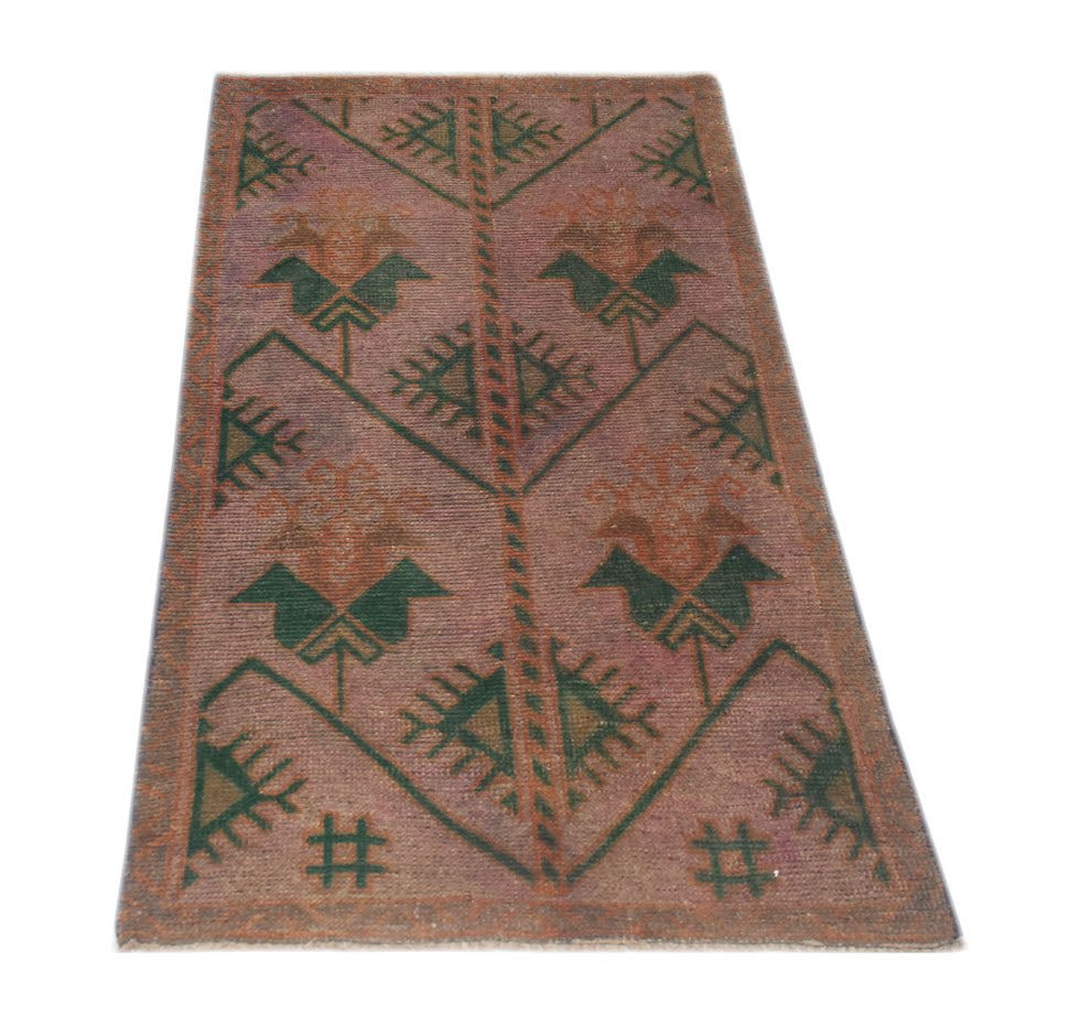 A handmade Afghan Baluch rug featuring a geometric pattern with stylized bird motifs in muted tones.
