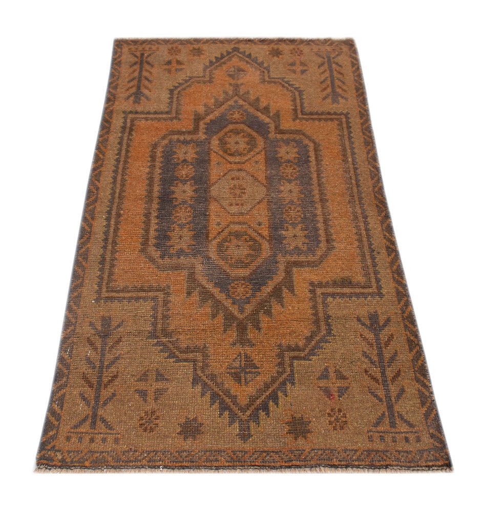 A handmade Afghan Baluch rug featuring a geometric medallion pattern in shades of brown and orange.