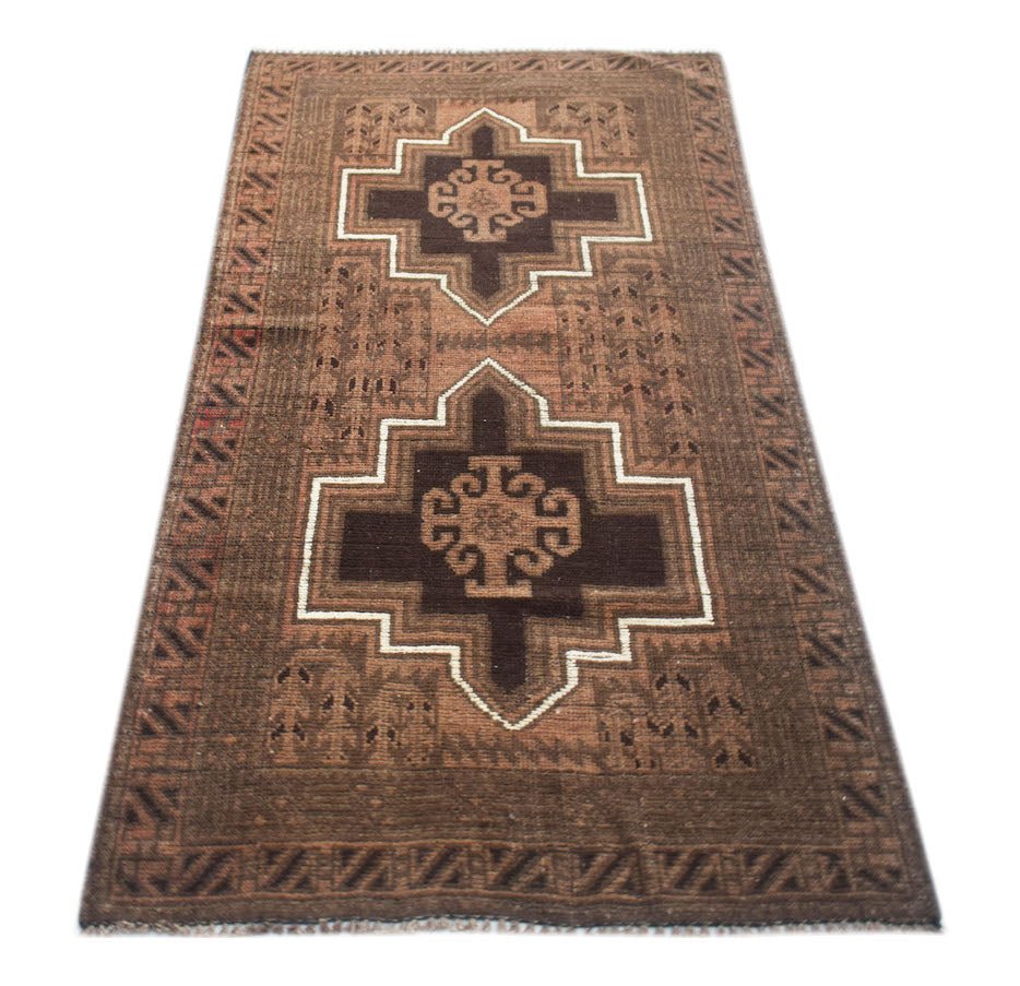 Handmade Afghan Baluch rug featuring two dark brown geometric medallions on a brown field.