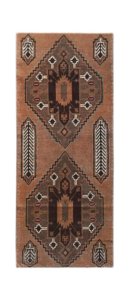 Handmade Afghan Baluch rug featuring two dark brown diamond medallions on a terracotta background.