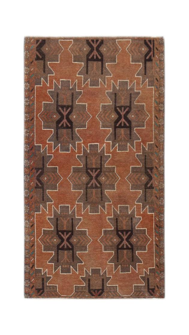 Handmade Afghan Baluch rug featuring a geometric pattern in shades of rust and dark brown.