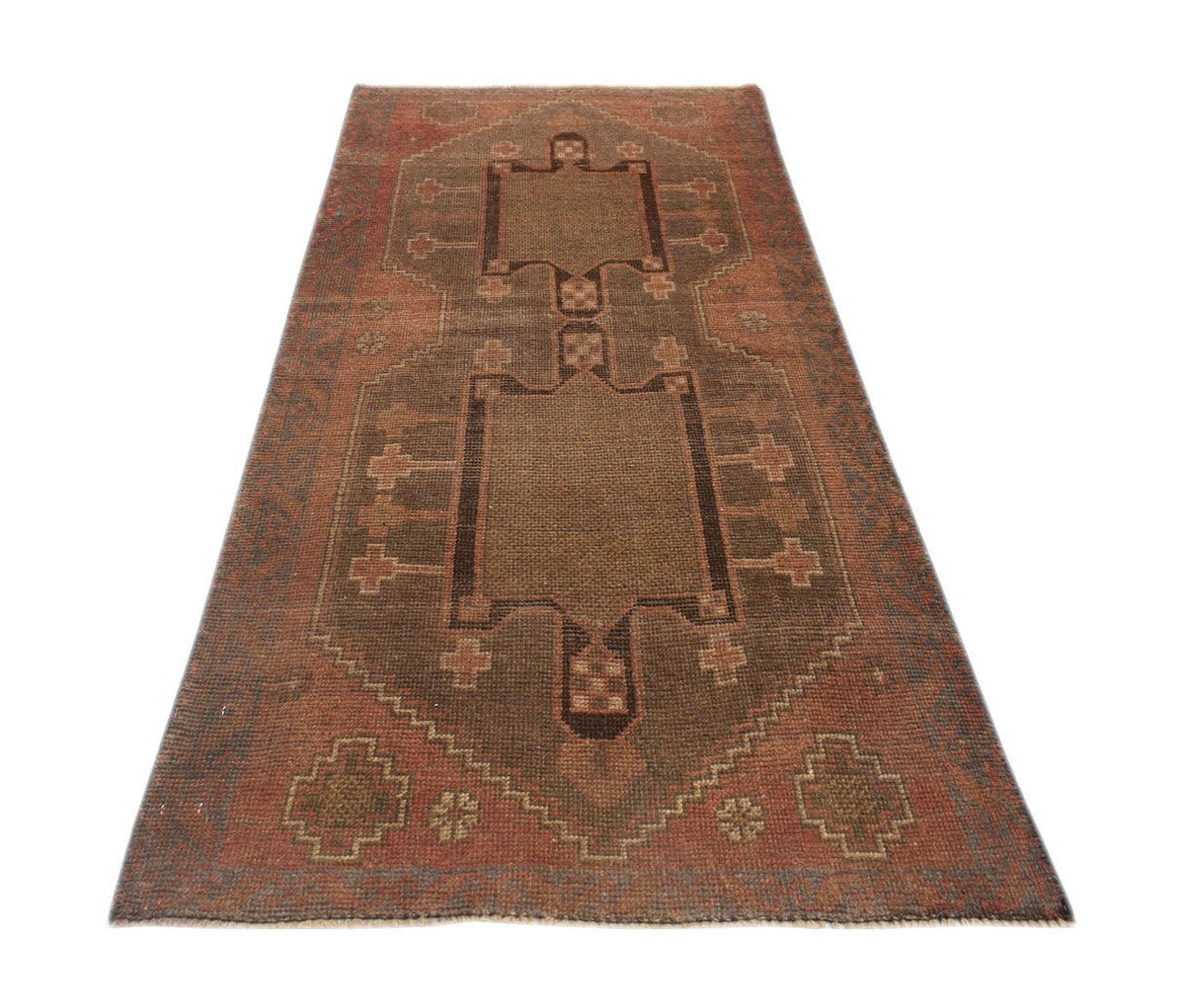 A handmade Afghan Baluch rug featuring a geometric brown central medallion on a rust-colored field.