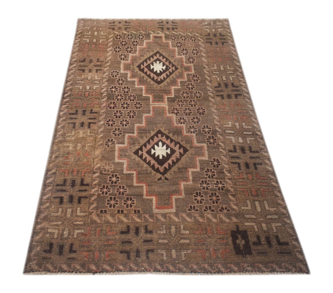 A handmade Afghan Baluch rug featuring a brown field with two central geometric diamond medallions.