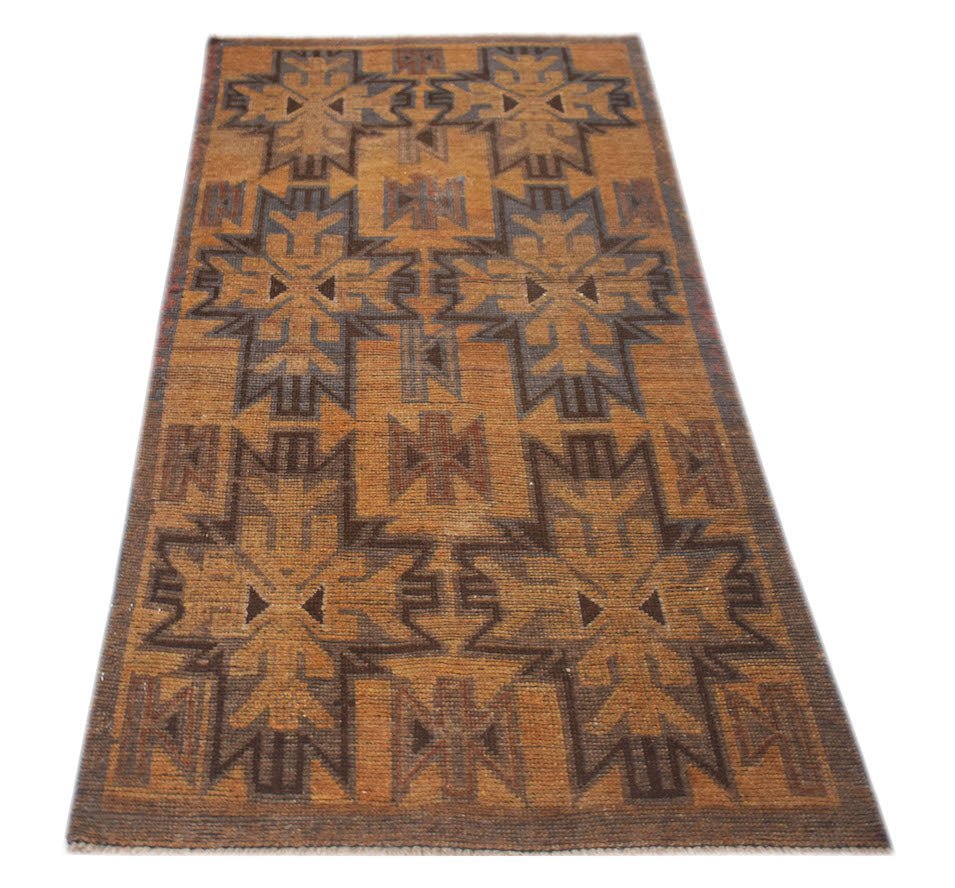 Handmade Afghan Baluch rug featuring a geometric pattern in shades of brown and tan.