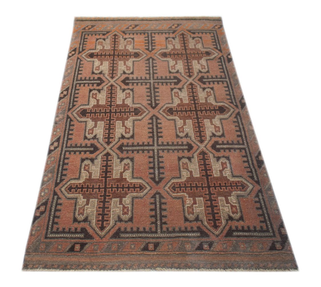 Handmade Afghan Baluch rug featuring a geometric pattern in shades of brown and rust.
