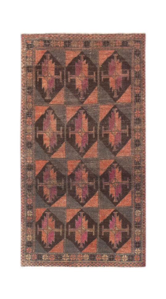 A handmade Afghan Baluch rug featuring a repeating diamond pattern in shades of red and dark brown.