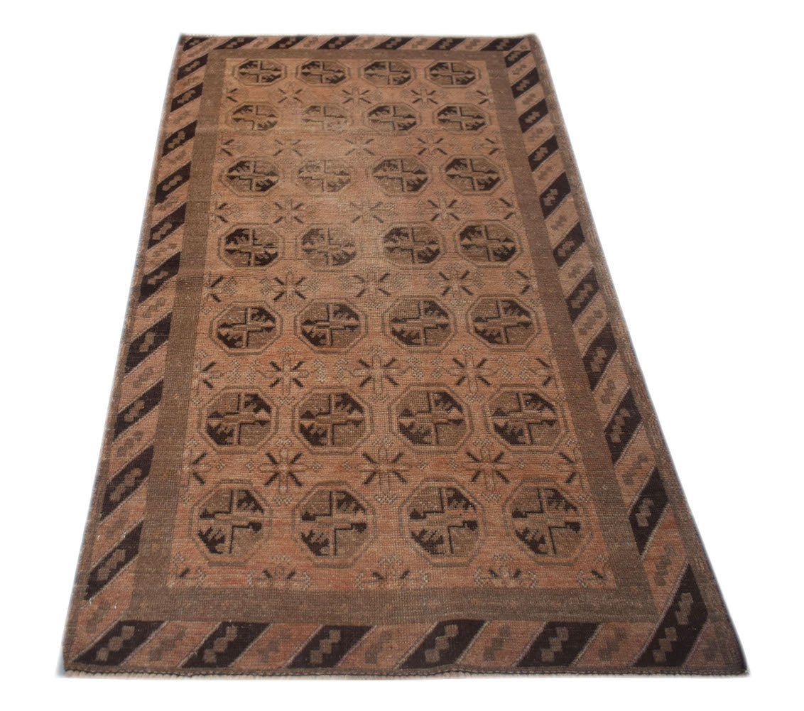 Handmade Afghan Baluch rug featuring a repeating geometric octagon pattern in brown and tan wool.