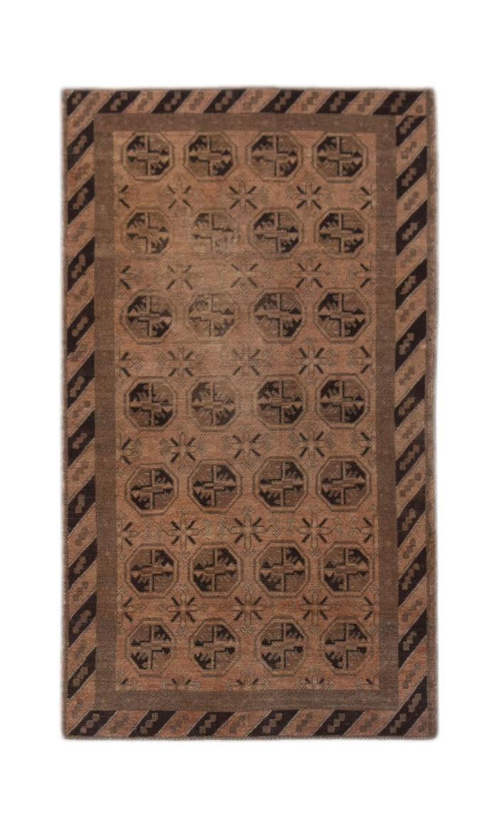 Handmade Afghan Baluch rug featuring a repeating geometric pattern in shades of brown and black.