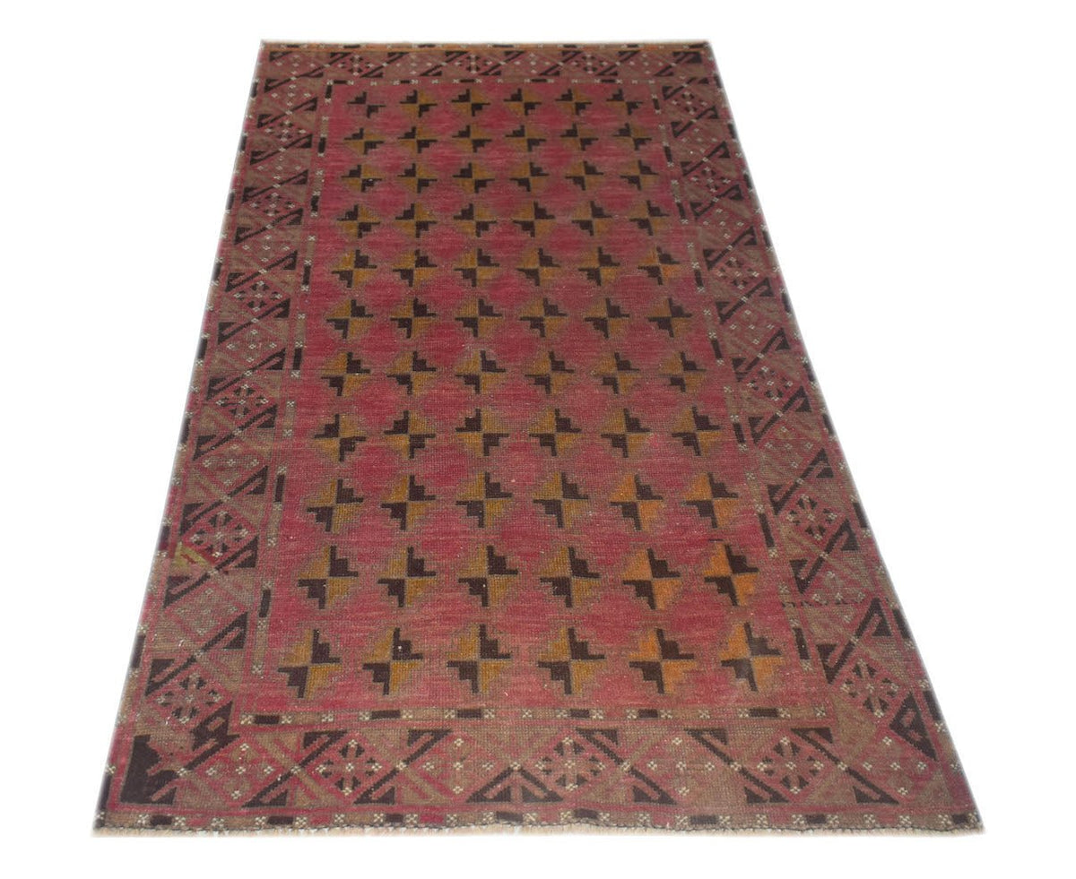 Handmade Afghan Baluch rug featuring a repeating geometric pattern in red, brown, and tan wool.