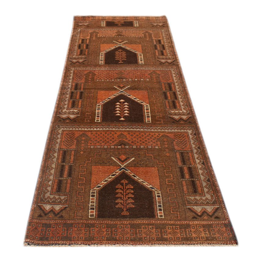 A handmade Afghan Baluch runner rug featuring three repeating geometric arch motifs in brown and rust.