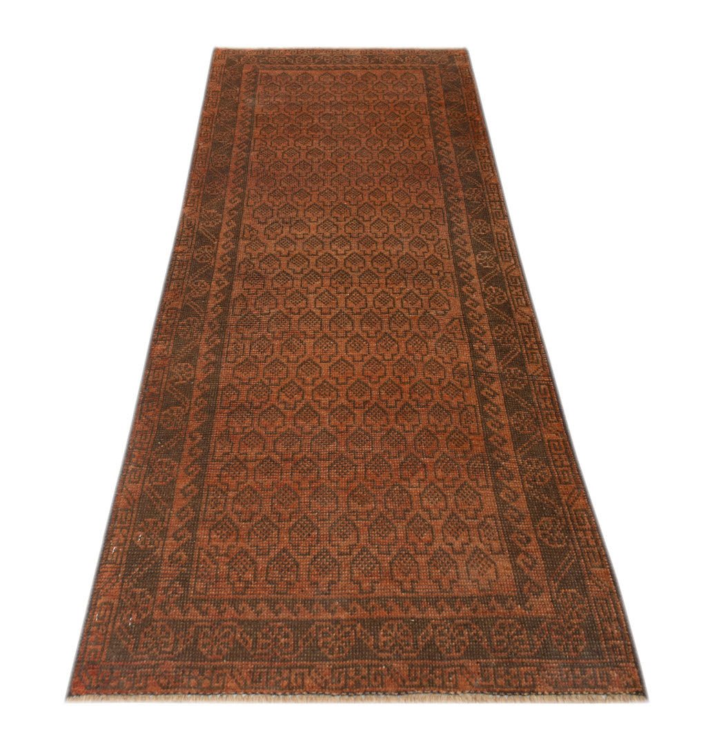 Handmade Afghan Baluch runner rug featuring a repeating geometric pattern in shades of rust and brown.