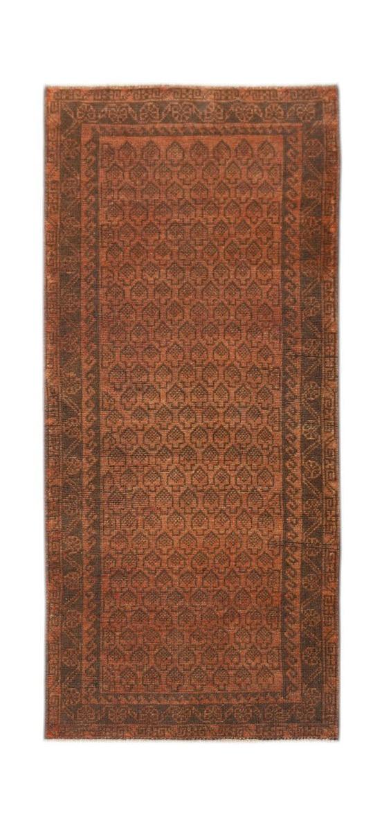 Handmade Afghan Baluch rug featuring a repeating leaf pattern in rust and dark brown tones.