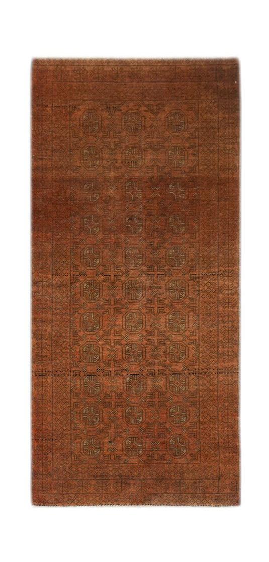 Handmade Afghan Baluch rug featuring a repeating geometric pattern in shades of rust and brown.