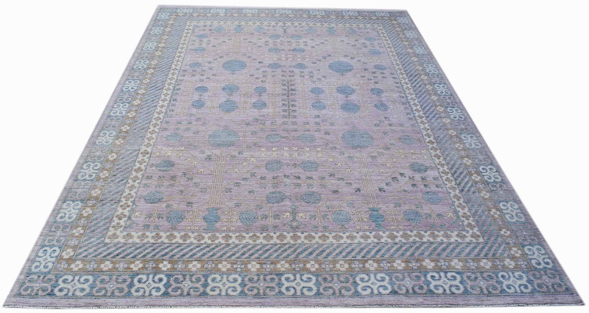 A rectangular Afghan Chobi rug featuring a lavender field with blue pomegranate motifs.