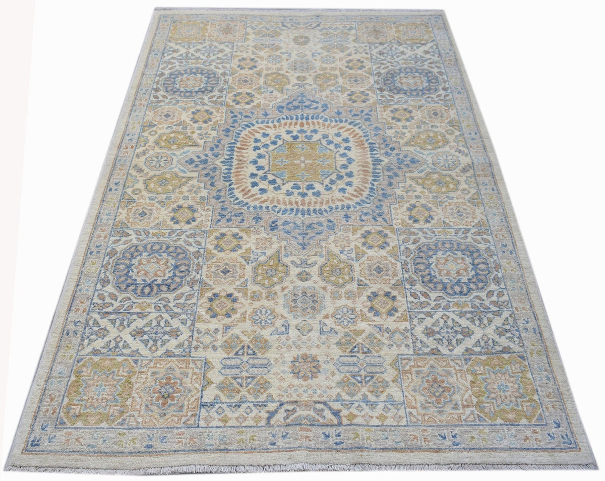 Hand-knotted Afghan Chobi rug featuring a geometric Mamluk design in soft blue, gold, and cream tones with a short fringe.