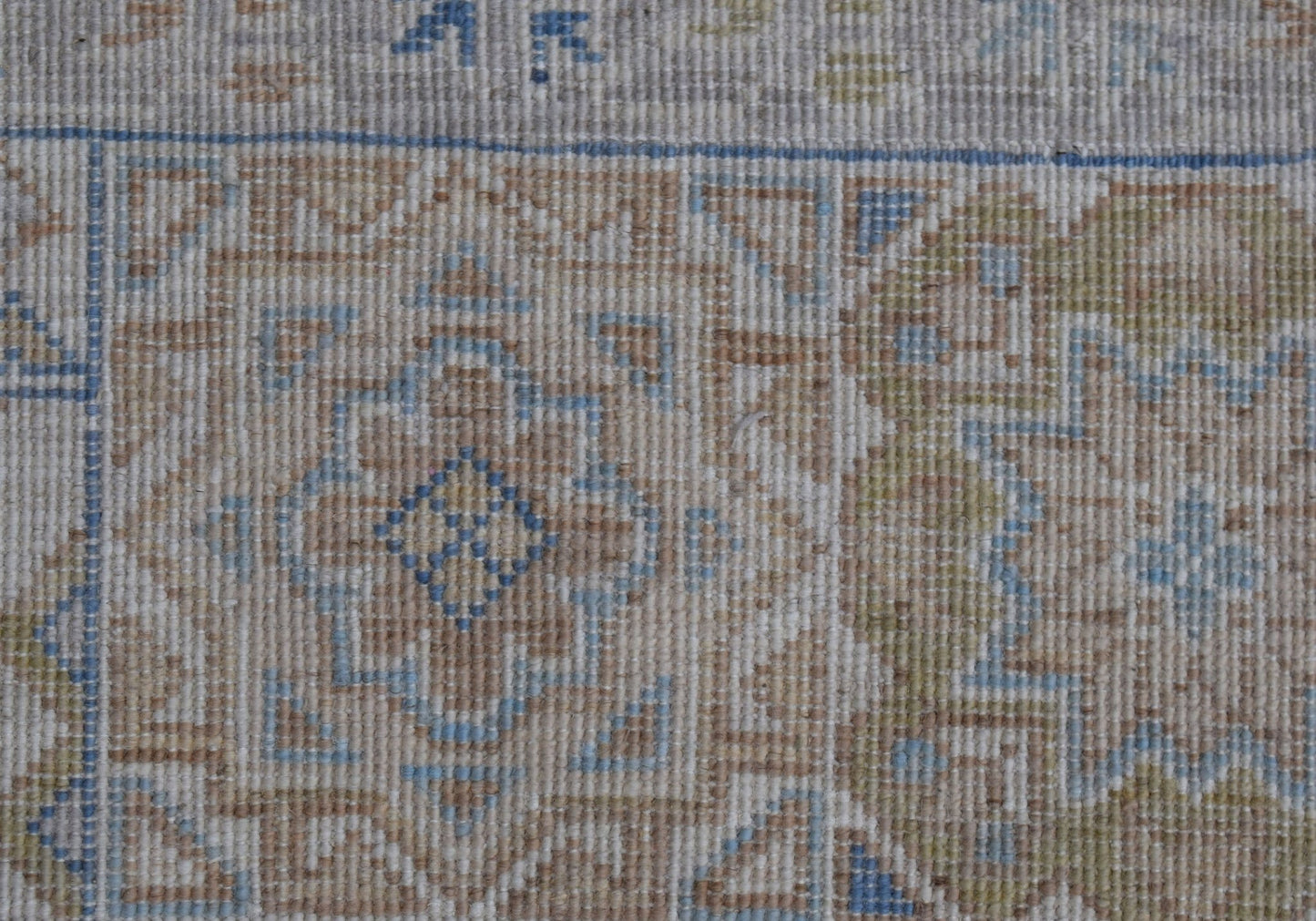 A close-up of a handwoven Afghan Chobi rug featuring a traditional Mamluk medallion pattern.