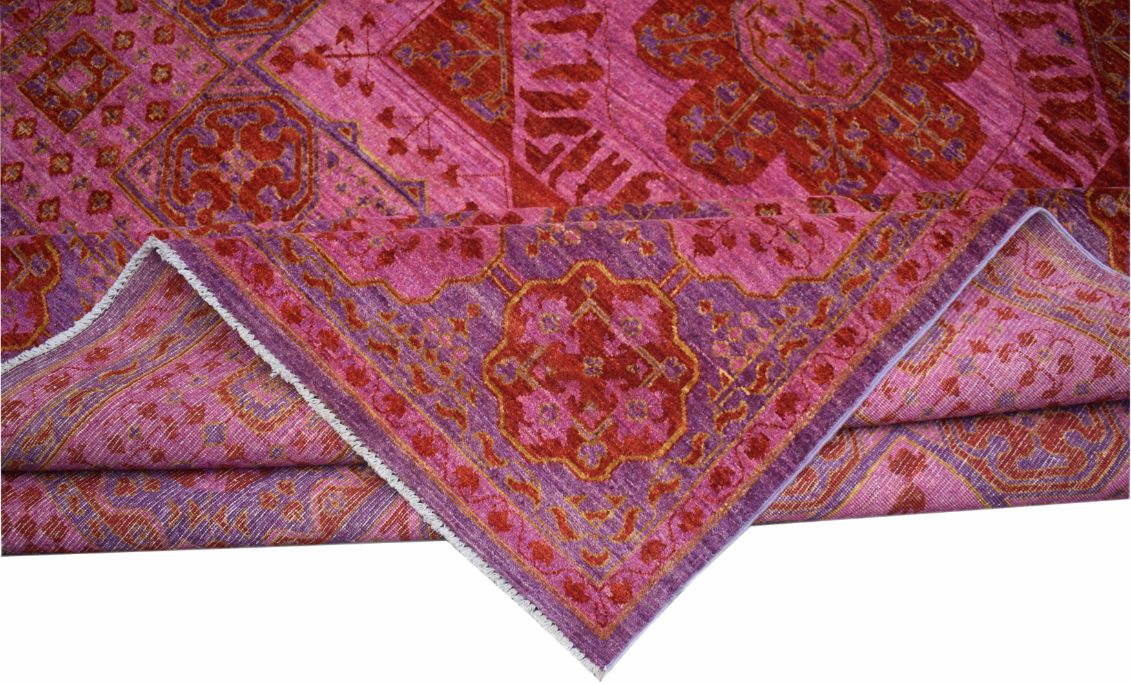 A handmade Afghan Chobi rug featuring a vibrant pink and red Mamluk medallion pattern.