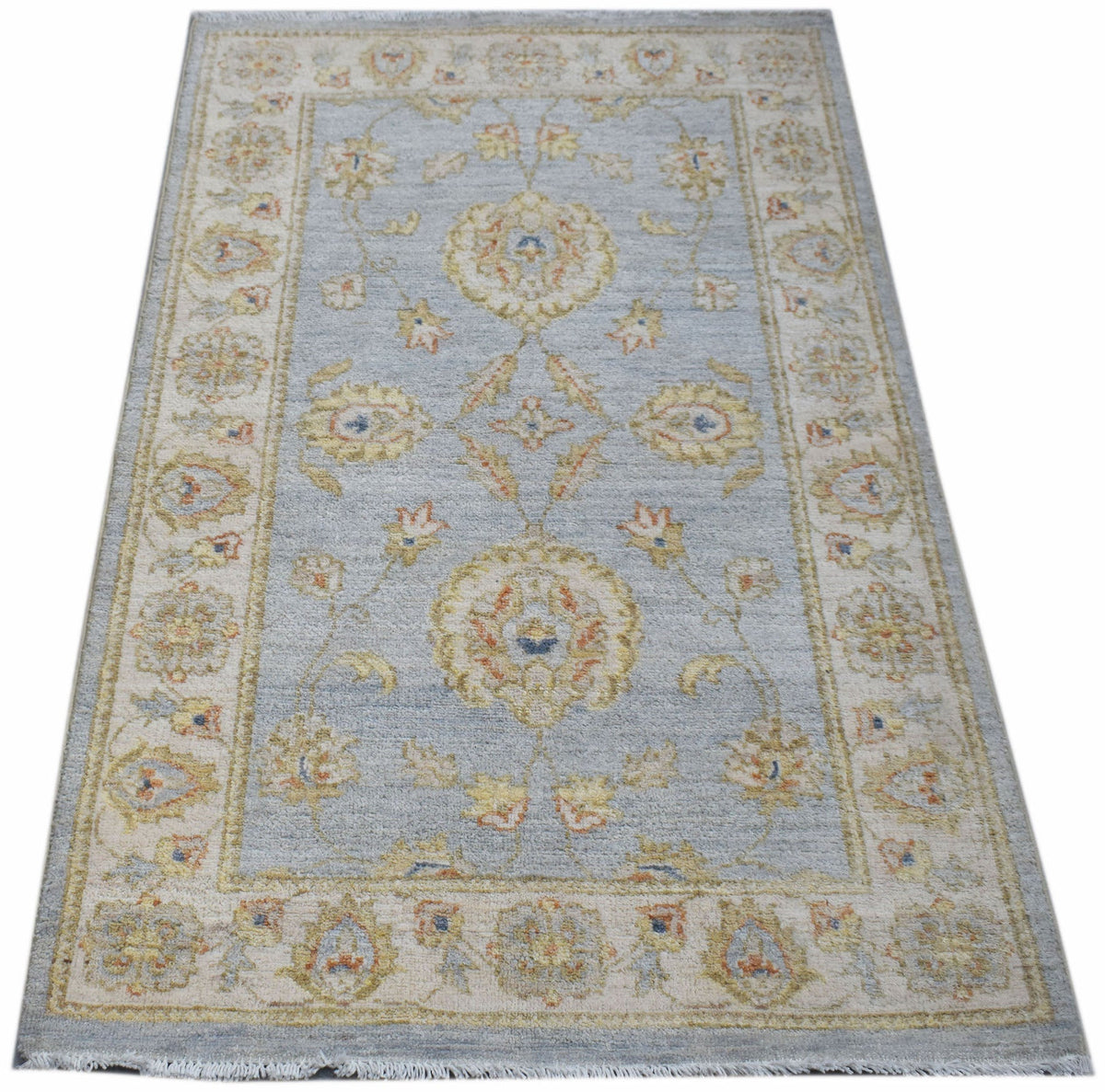 A rectangular Afghan Chobi rug featuring a light blue field with traditional floral patterns.