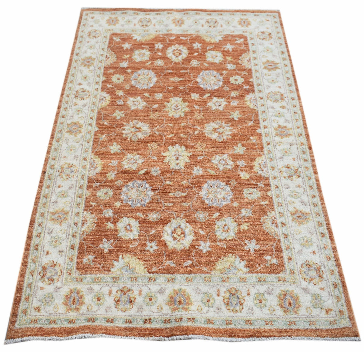 Hand-knotted Afghan Chobi rug with a terracotta field, floral motifs, and a cream border in a low-pile wool finish.