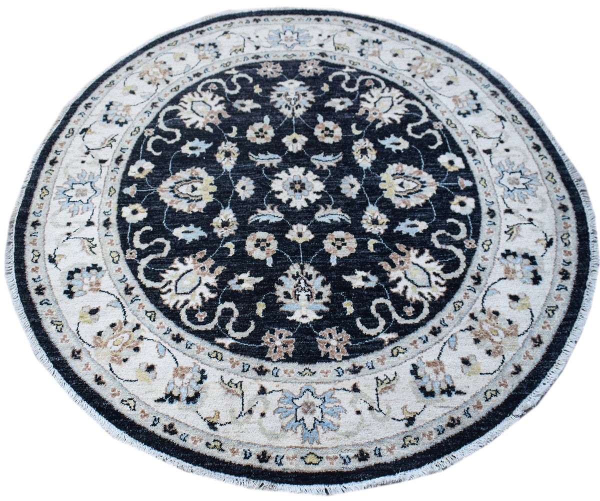 A round, handwoven Afghan Chobi rug featuring a dark central medallion with intricate floral motifs.