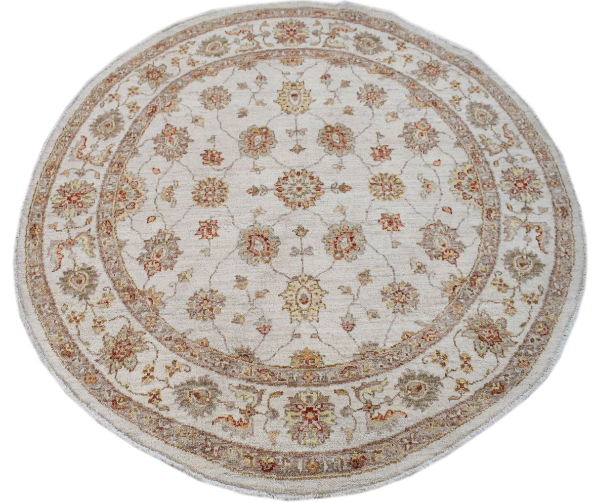A round Afghan Chobi rug featuring a traditional floral pattern in earthy tones on a cream base.
