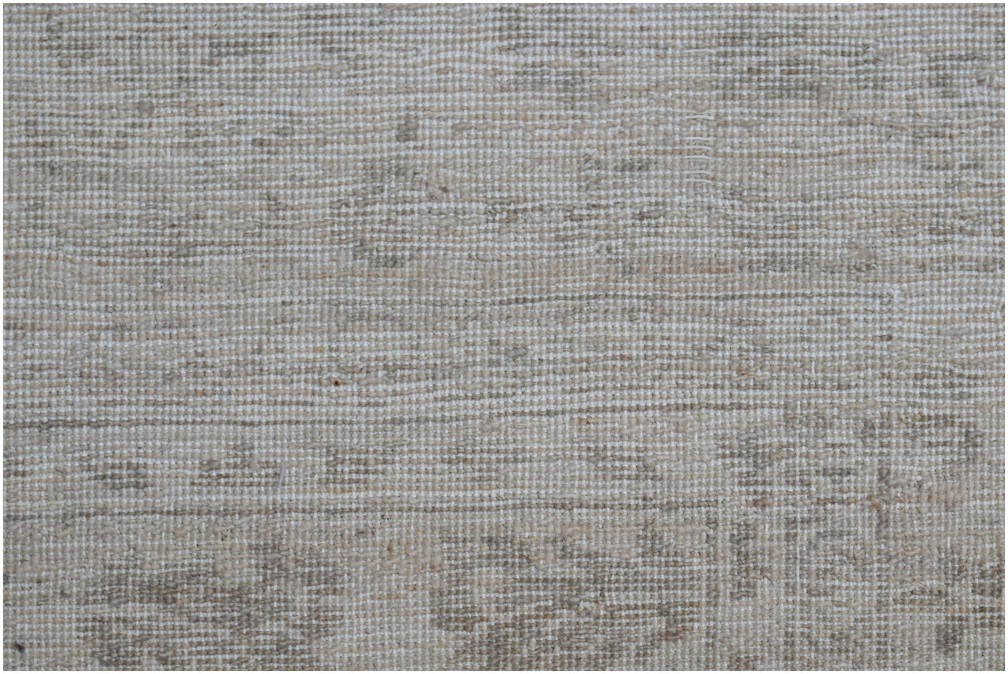 A close-up of a handwoven Afghan Chobi rug featuring a neutral, textured wool pattern.
