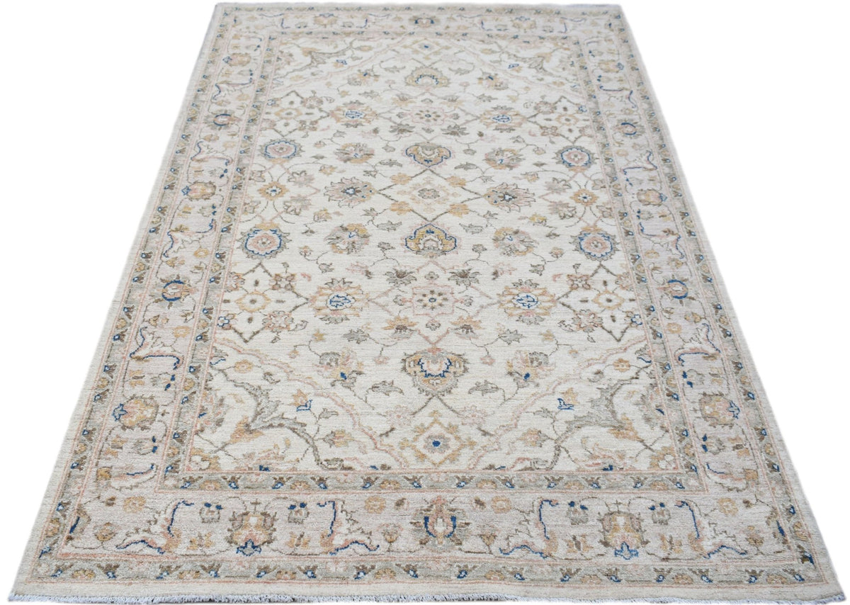 A rectangular Afghan Chobi rug featuring a traditional floral pattern in soft beige, blue, and tan.