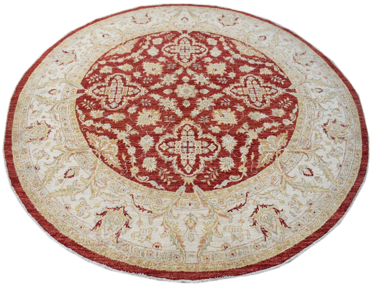 A round Afghan Chobi rug featuring a red central medallion with intricate floral patterns.