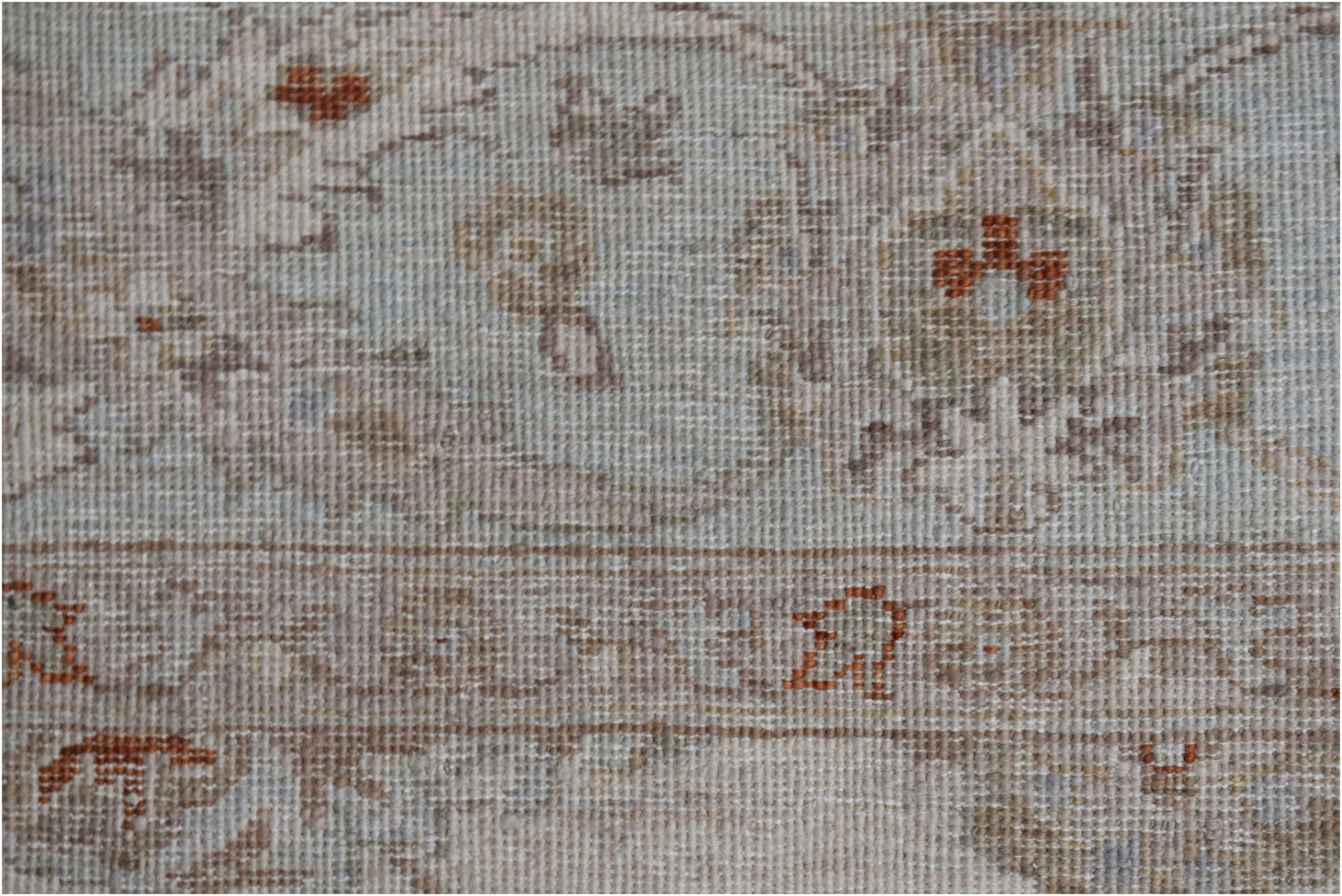 A close-up of a handwoven Afghan Chobi rug featuring traditional patterns in soft, earthy tones.