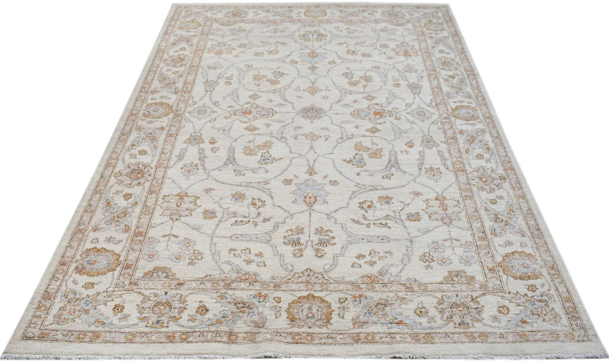 Hand-knotted Afghan Chobi rug with a cream base, intricate floral patterns in soft blue and tan, and a low wool pile.