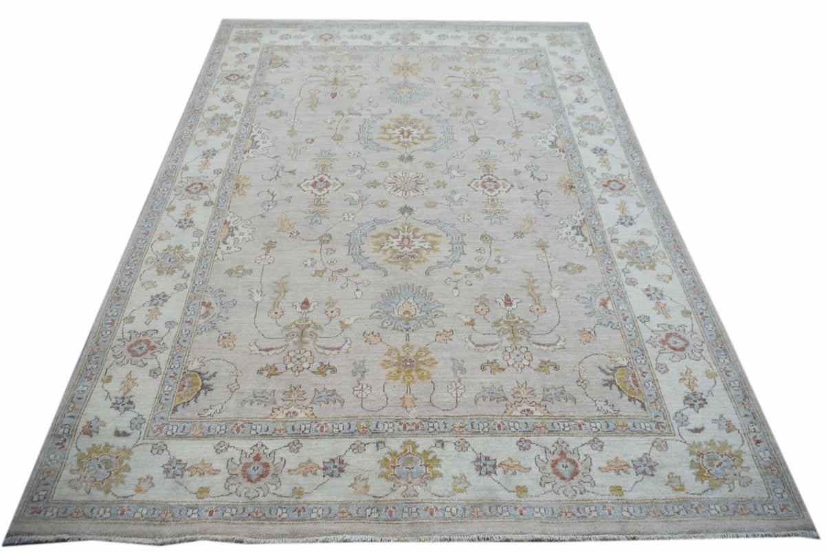 A rectangular Afghan Chobi rug featuring a traditional floral pattern in soft, earthy tones.