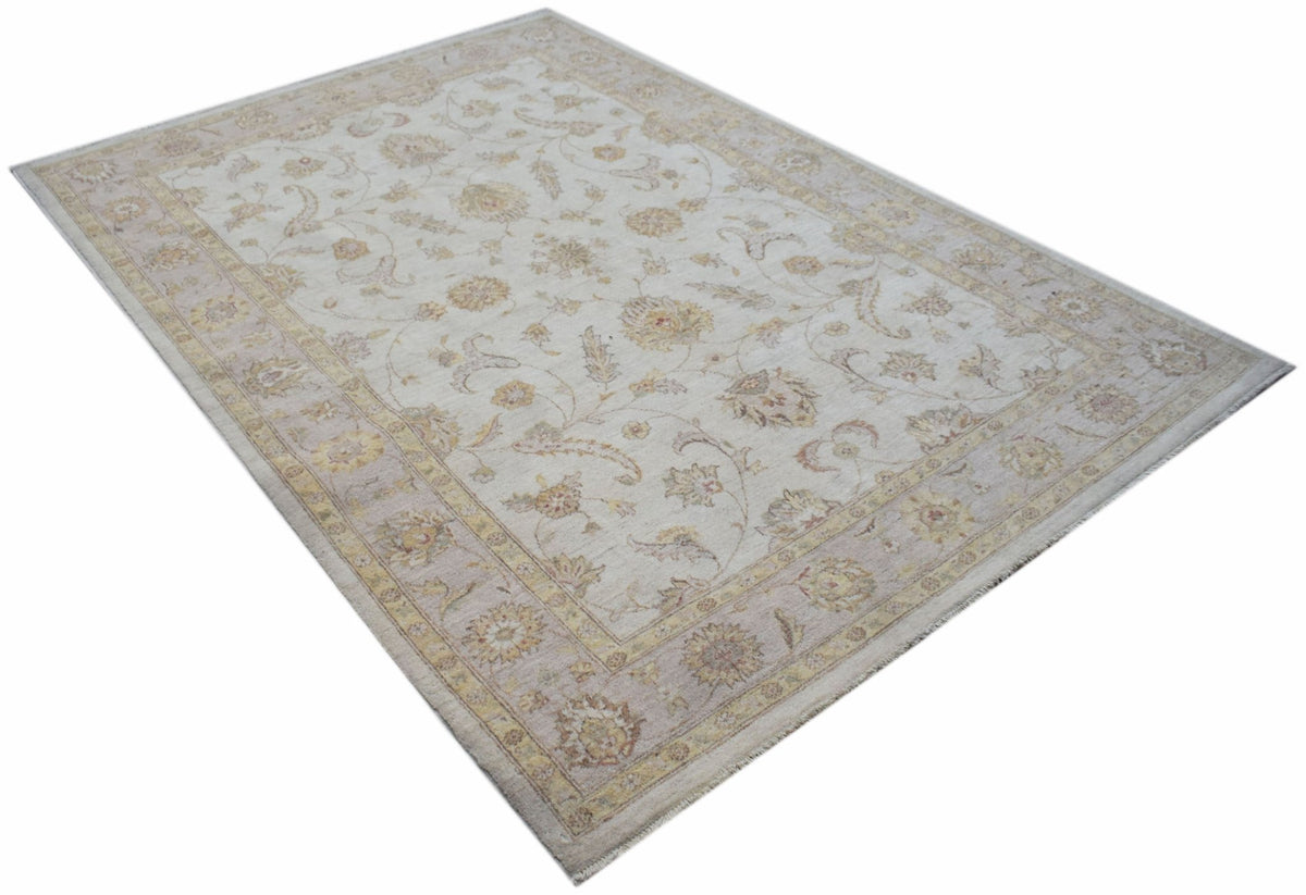 An Afghan Chobi rug featuring a traditional floral pattern in soft beige and muted earth tones.