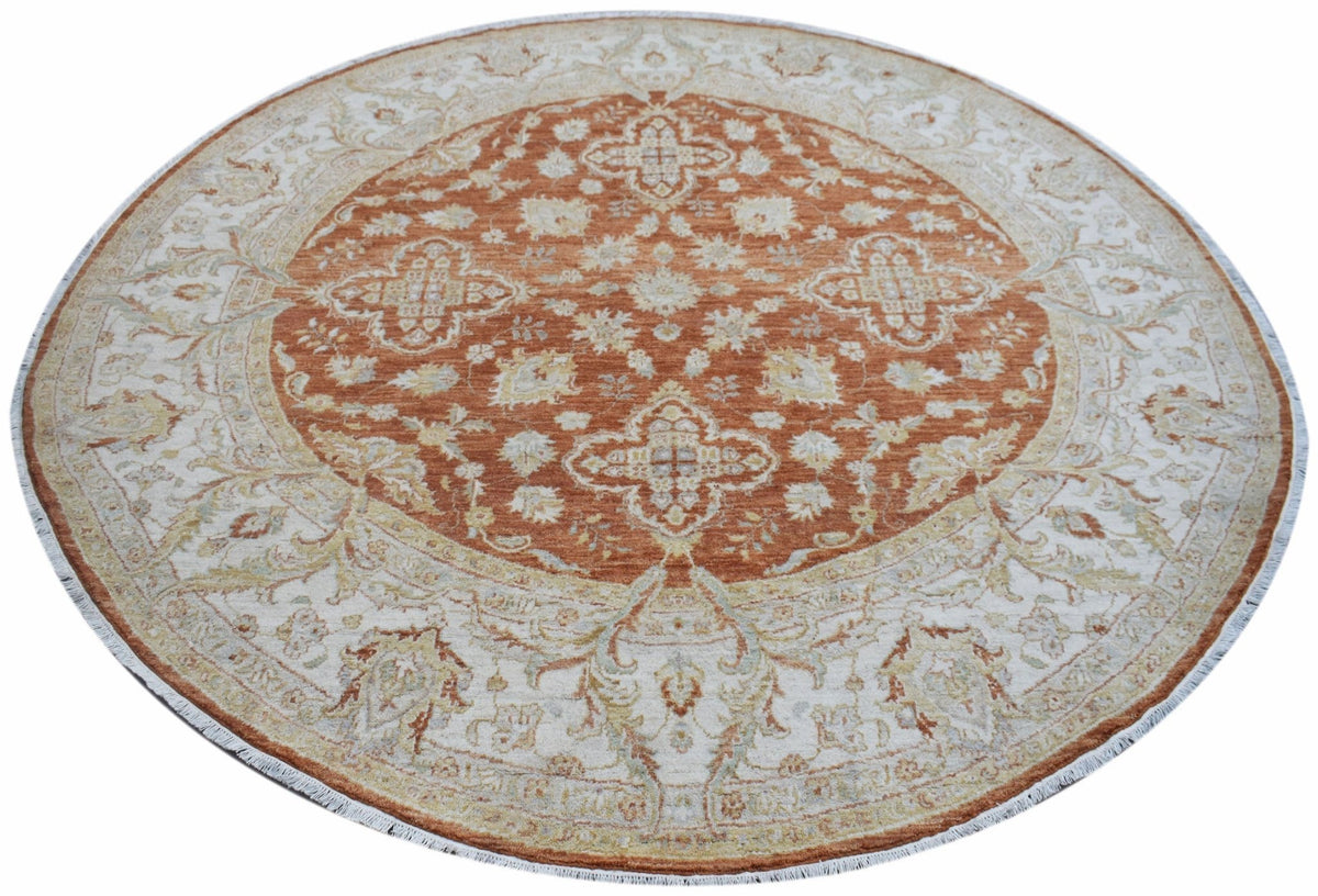 A round Afghan Chobi rug featuring a rust-orange center with intricate floral patterns.