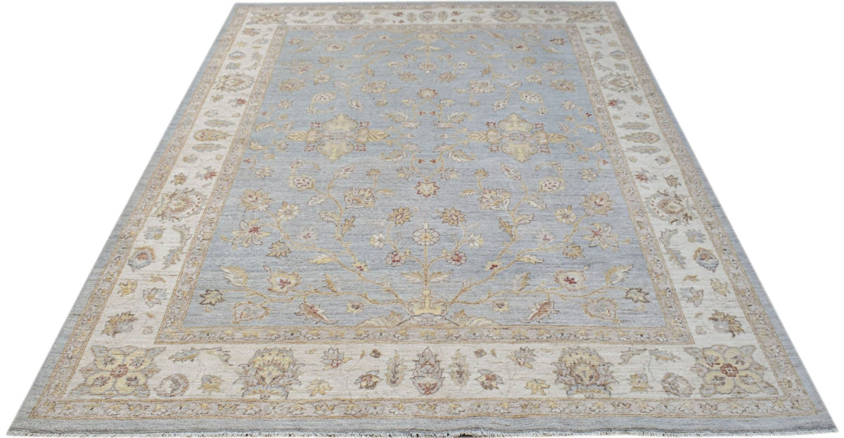 Hand-knotted Afghan Chobi rug in soft blue with a cream border and intricate floral vine patterns.