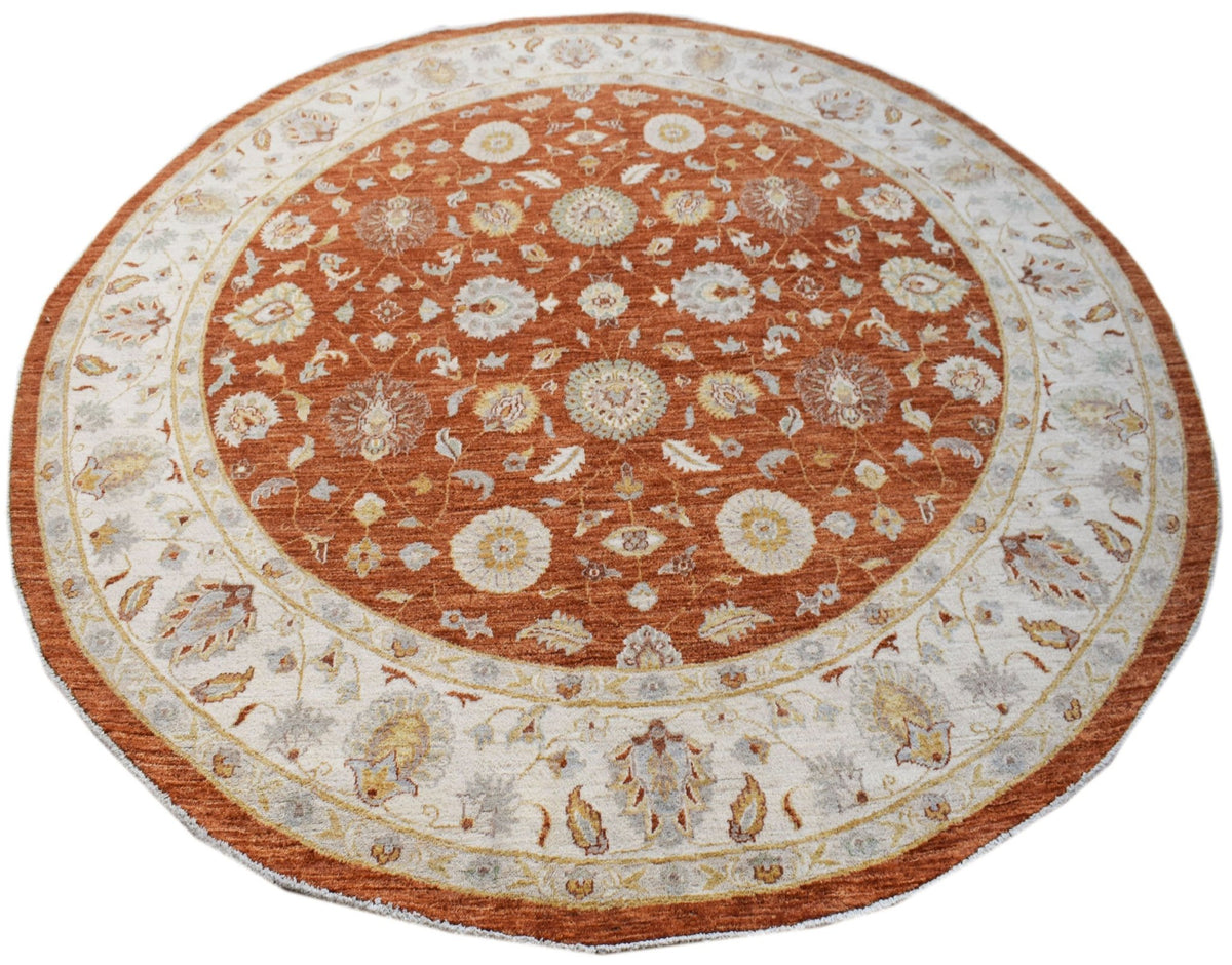 A round, handwoven Afghan Chobi rug featuring a traditional floral pattern in rust and cream tones.