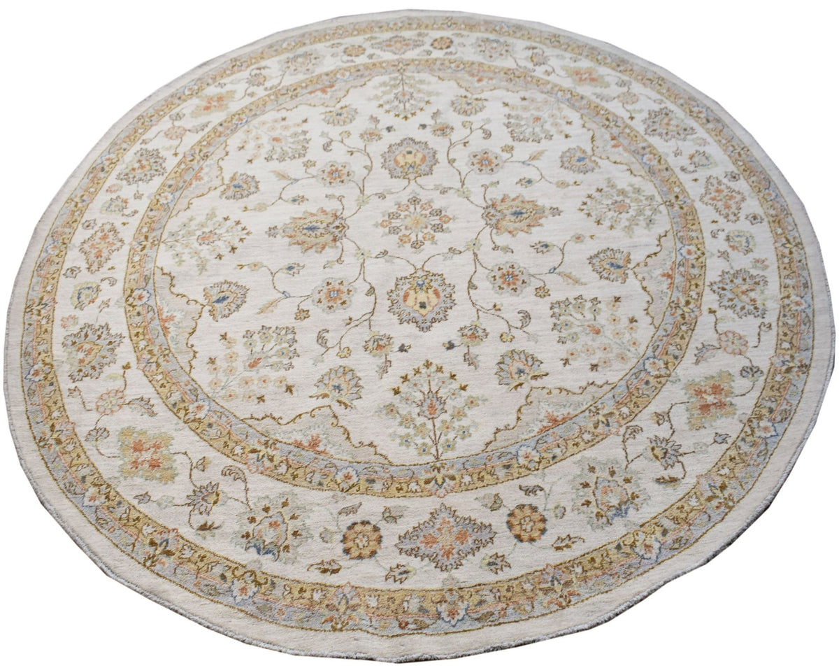 A round Afghan Chobi rug featuring a traditional floral pattern in soft, earthy tones.